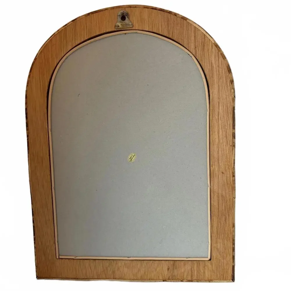 Vintage Arched rattan mirror with a natural, aged finish.